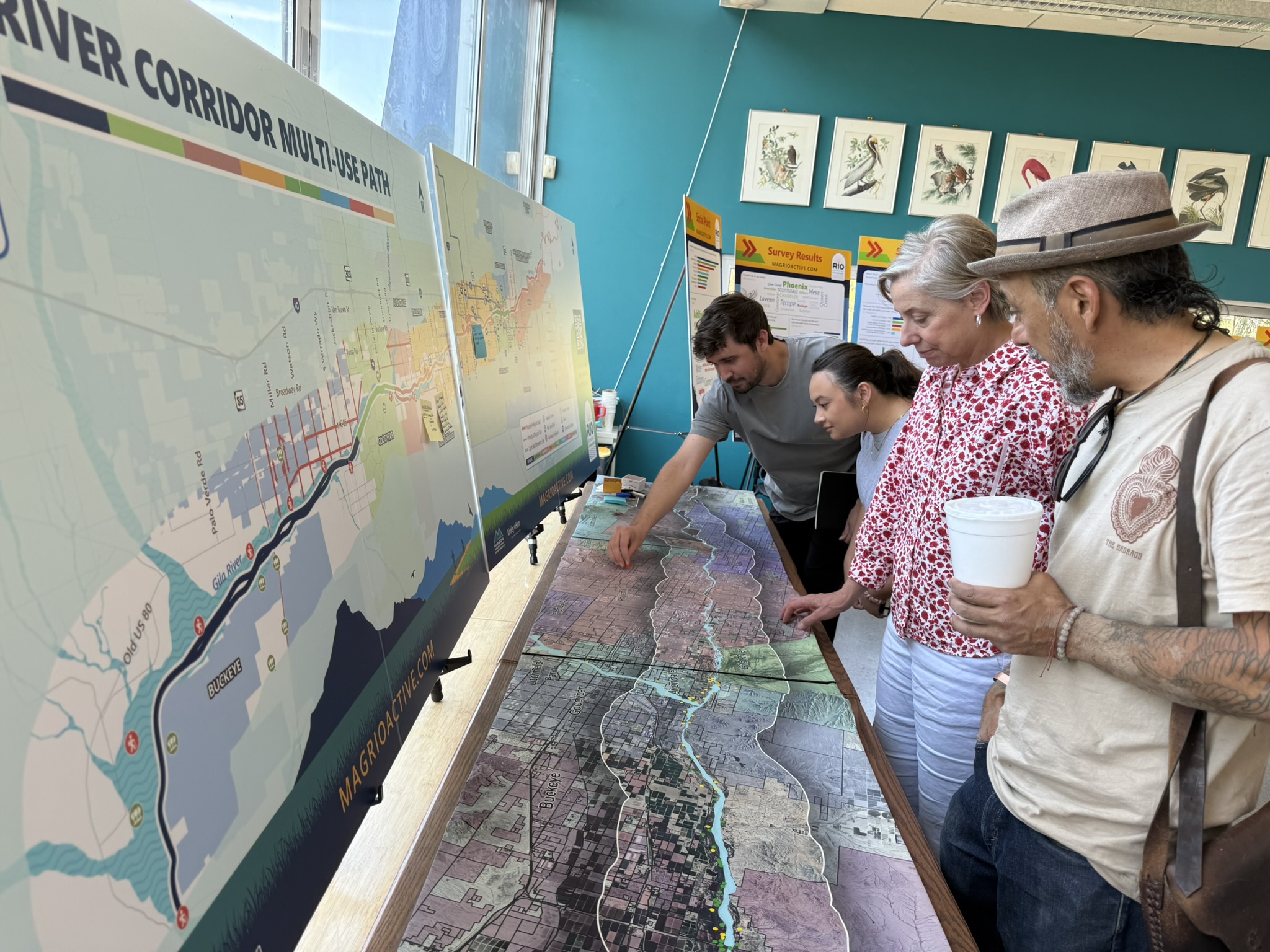 People analyzing topographic map of project area at public response event. Taking place at Audobon Center.