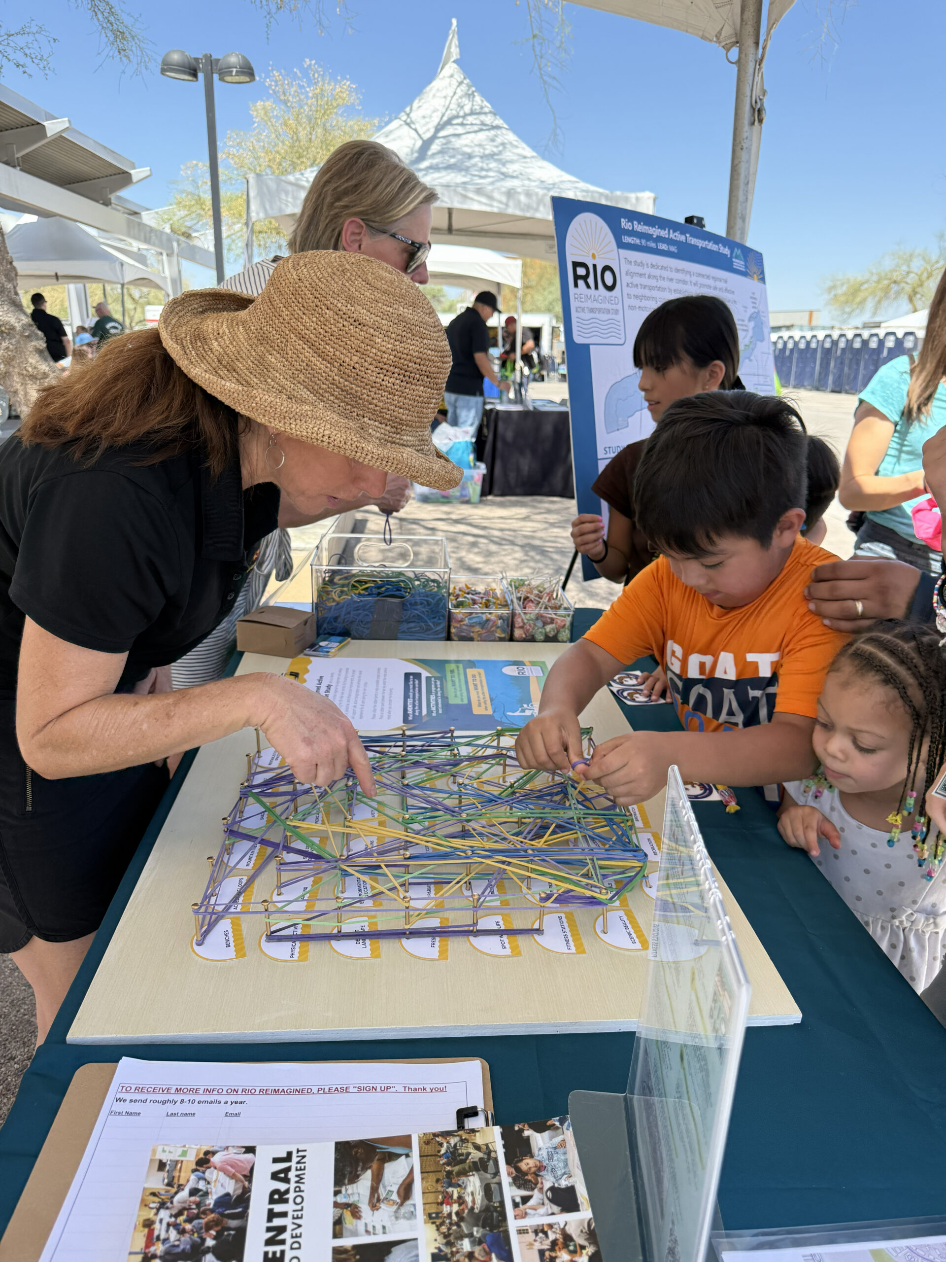 Children participating in rubber band activity meant to gather public response related to the project. Event taking place at Phoenix Light Rail opening.