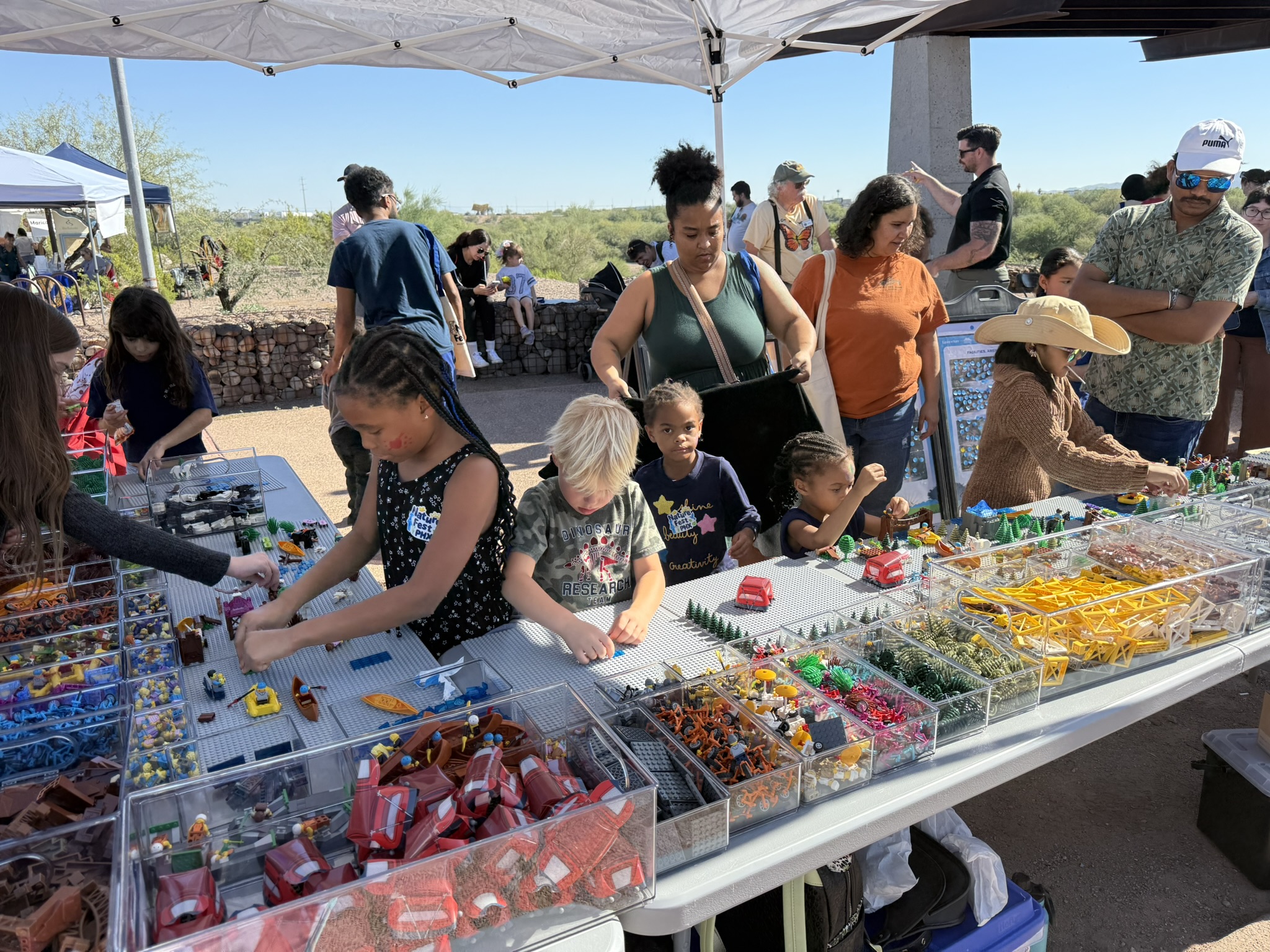 People participating in Lego public response event. Taking place at Pheonix Nature Festival.