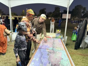 People analyzing topographic map of project area at public response event. Taking place in the City of Tempe at Boo Festival.