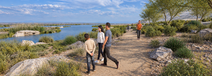 People walking and observing desert scenery along walking trail.